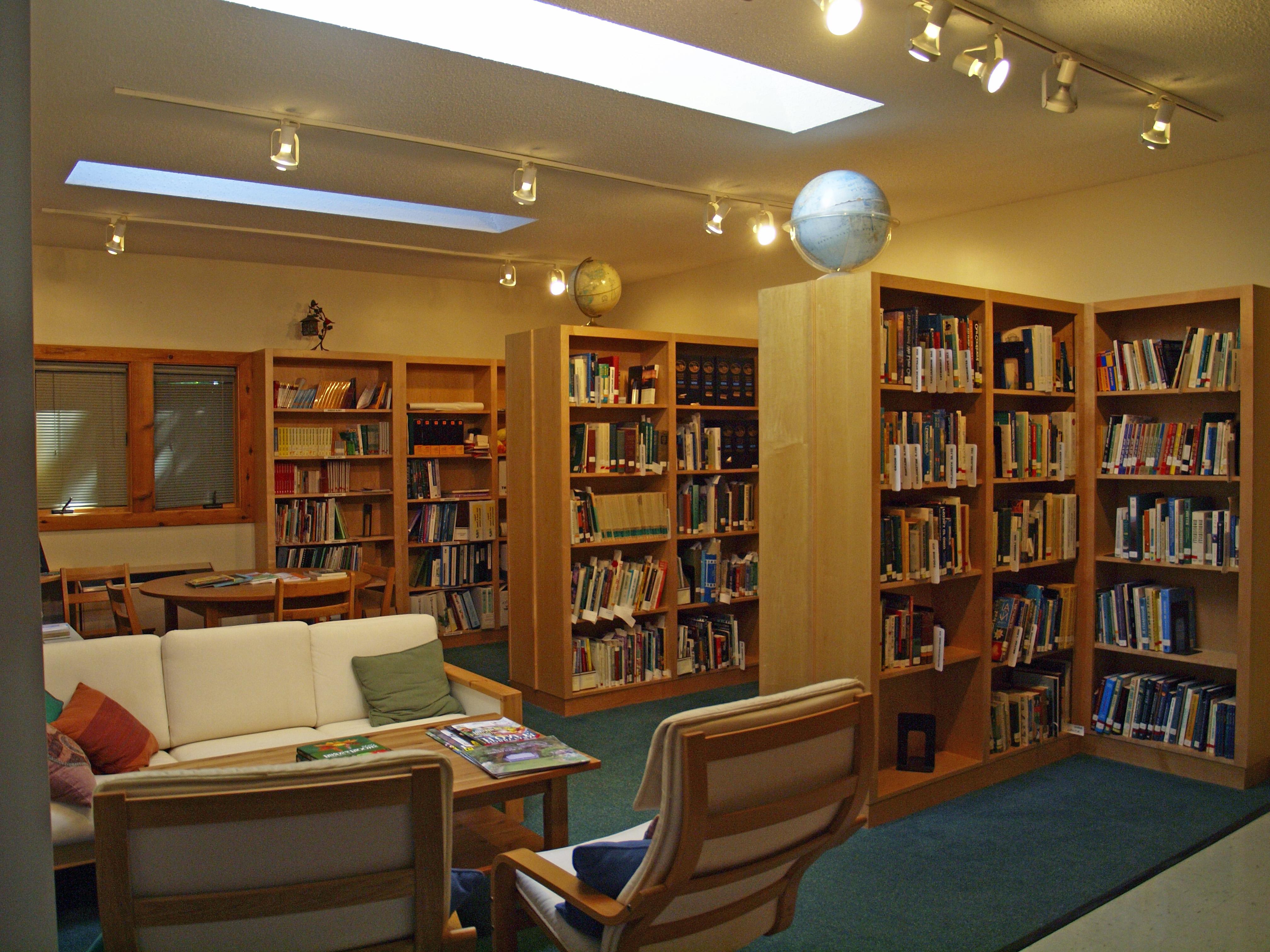 A study space with bookshelves and couches located in the Nature Center